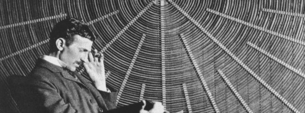 Nikola Tesla 1896 in front of a large spiral coil [Photo Provided = German Patent and Trade Mark Office (DPMA)]